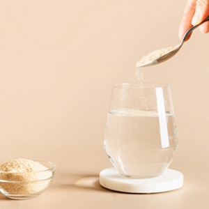 Woman mixing fiber into glass of water